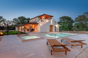 A two-story house with a swimming pool, outdoor seating, and a well-maintained garden. - Modern, newly built villa located in Kavran (Kavran)