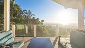 A balcony with a view of palm trees and the ocean. - Pu'ukala Sunset Estate W/ Amazing Ocean Views! 3 Bedroom Home by RedAwning (Kailua-Kona)