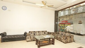 A living room with a sofa set, a coffee table, and a ceiling fan.