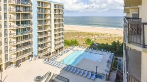 A hotel with a pool and beach view. - Spacious 2 BR 2 Bath Ocean Front building overlooking Pool (Ocean City)