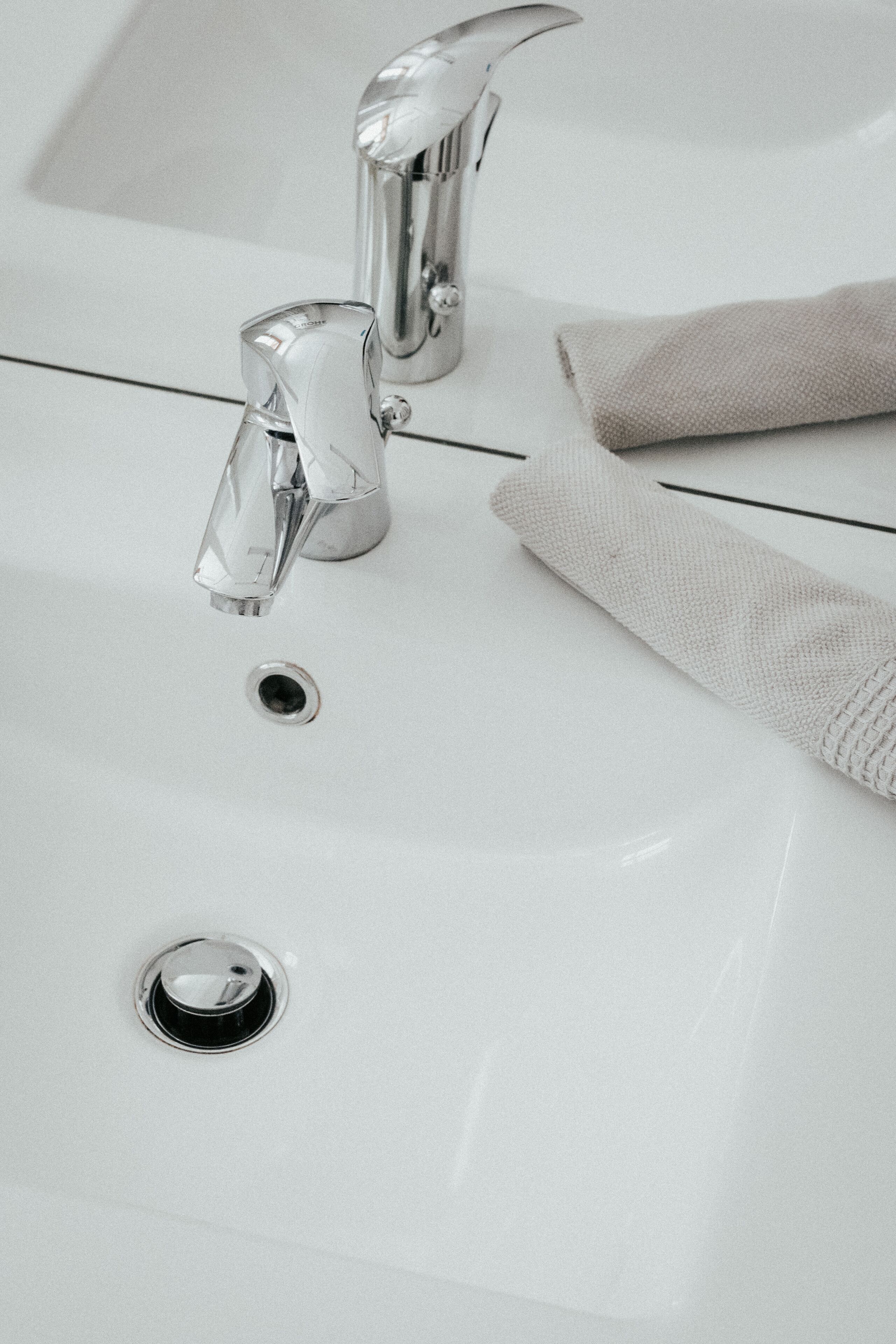 Un lavabo de salle de bain avec un robinet chromé et une serviette.