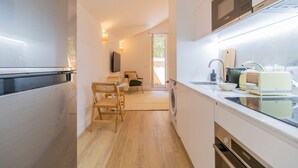 A modern kitchen with a built-in oven, a sink, and a vintage toaster. - Urban House Marquês - F - by LovelyStay (Porto)