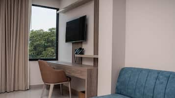 A modern room with a desk, chair, and a blue sofa.