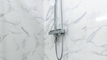 Shower, hair dryer, towels, toilet paper