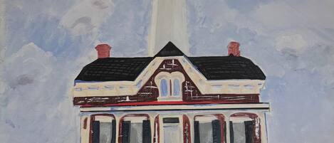 A house with a lighthouse, a front door, and a chimney.