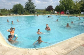 A swimming pool with people enjoying the water.