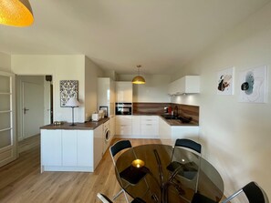 Enjoy cooking in this well-equipped kitchen with a central island, oven, and sink.