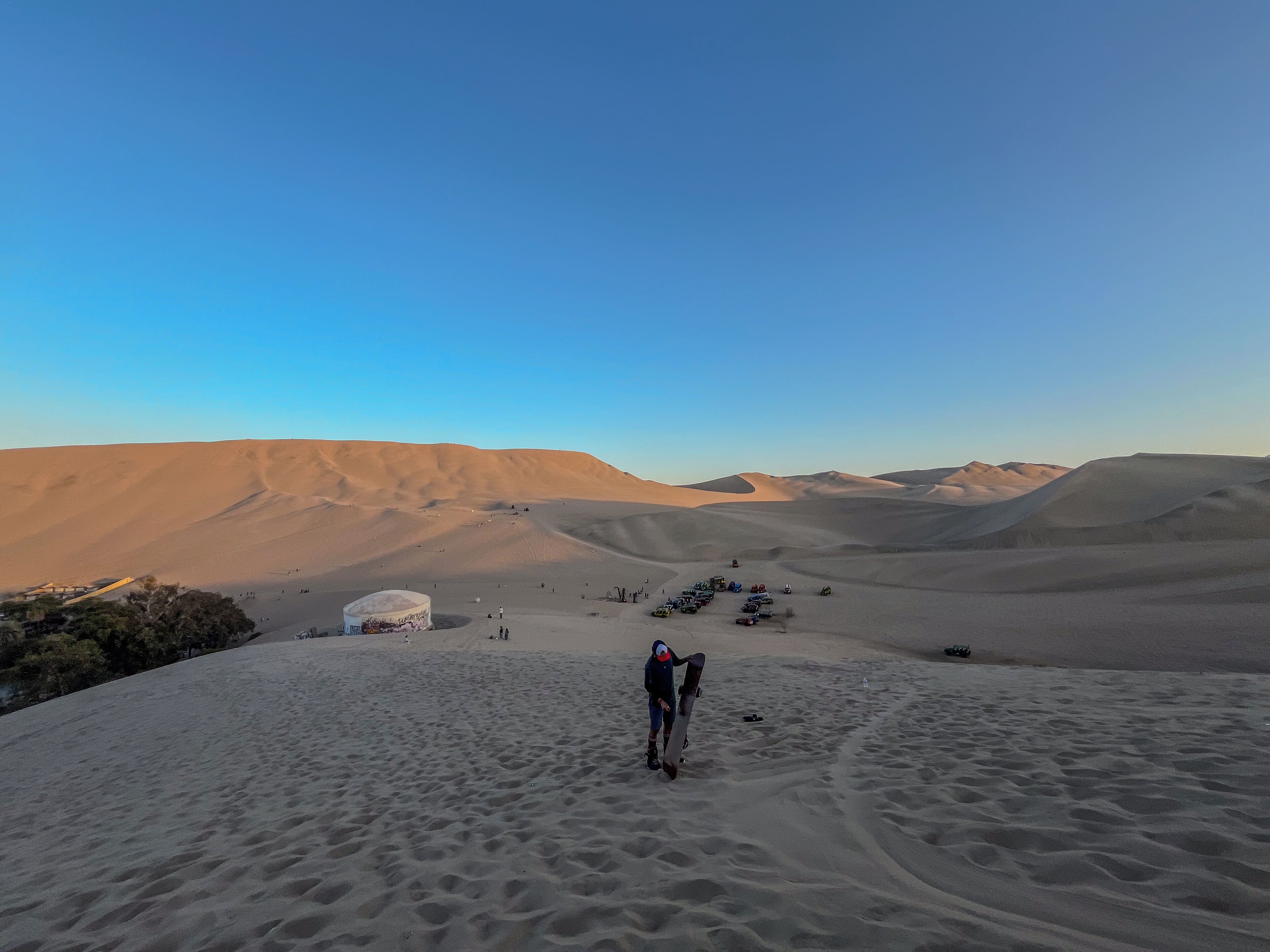 A desert landscape with sand dunes and a clear sky.