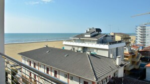 A coastal building with a balcony overlooking the beach. - Lovely Flat With Nice Terrace in Bibione-beahost (San Michele al Tagliamento)