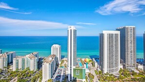 A high-rise hotel with a view of the ocean, featuring multiple balconies and a pool area. - ★★★★★ Stylish Retreat at Lyfe Resort Steps Away from the Ocean with Rooftop Pool (Hollywood)