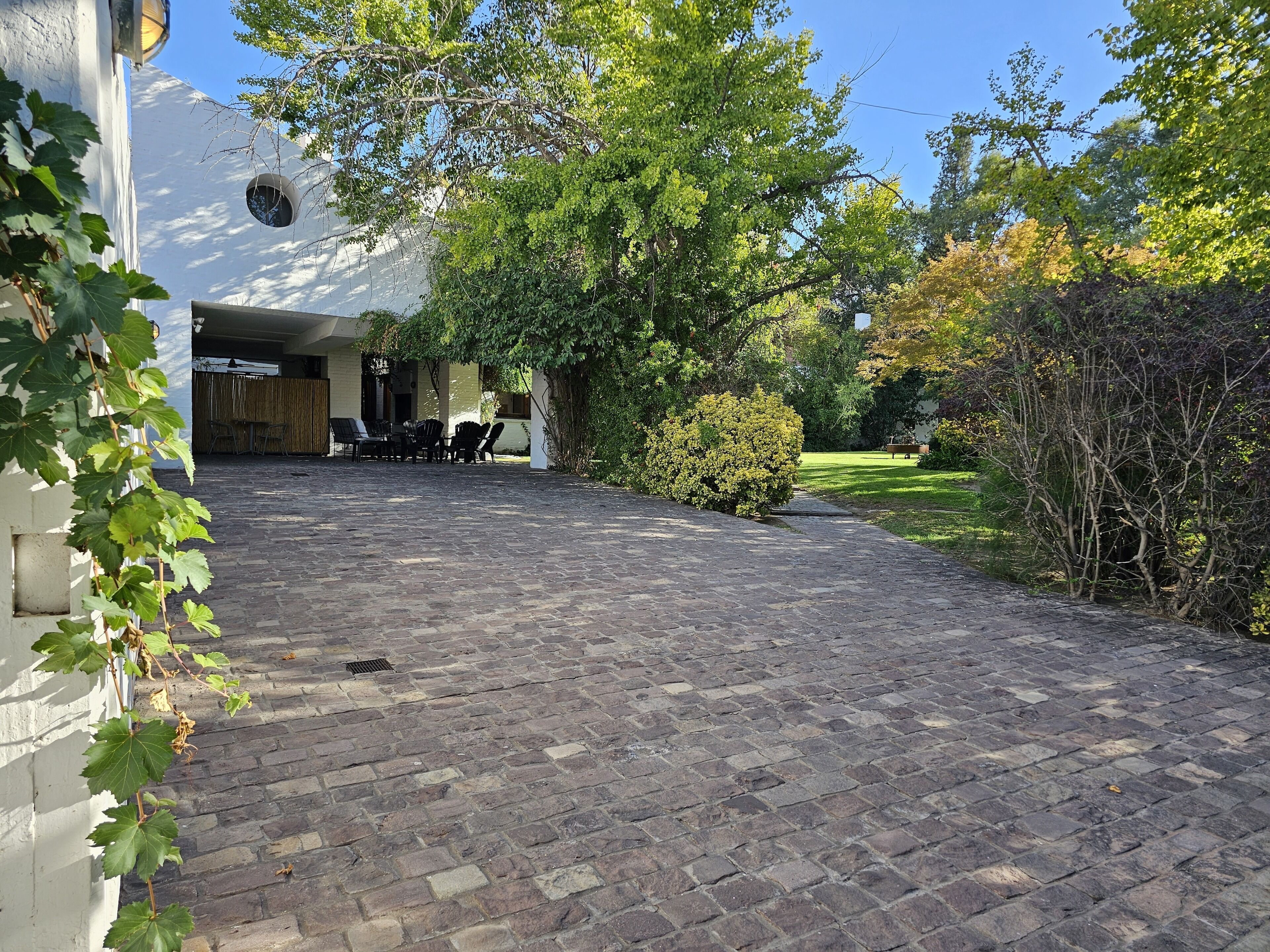 A paved courtyard with a seating area and a building entrance.