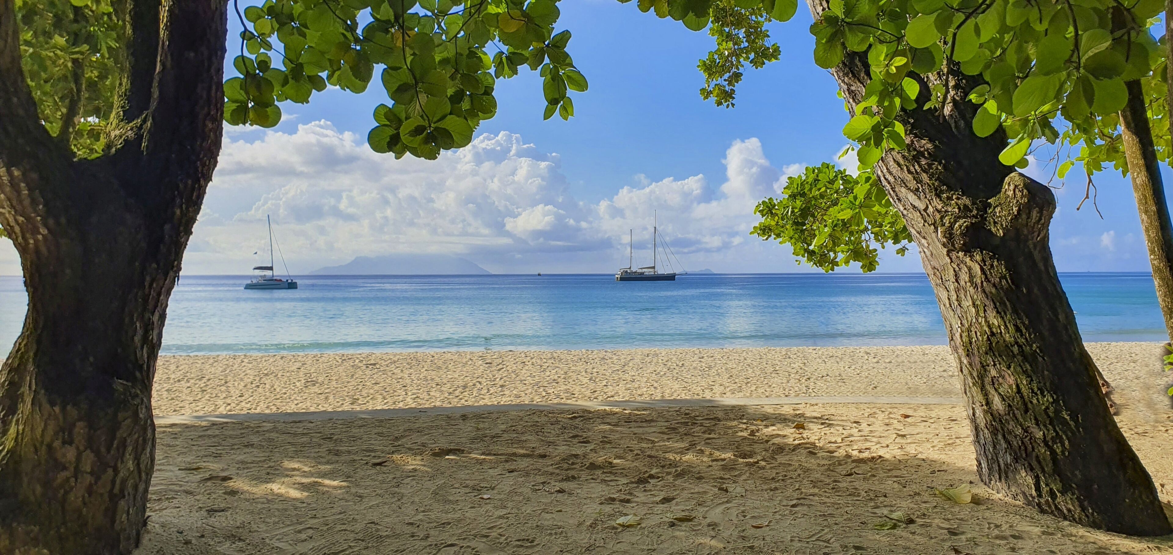 On the beach, white sand, sun loungers, beach towels