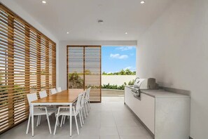 Outdoor dining - New, Boutique, 2BR Modern Condo + Pool + Gym - 5 min walk to Grace Bay Beach! (Grace Bay)
