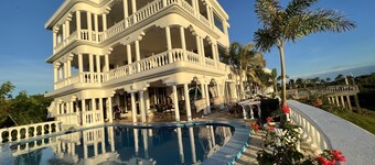 Room w/ ocean view balcony next to the beach. 2 pools, fire pit, gardens & more!
