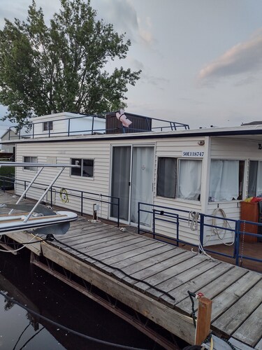 Unique houseboat rental with private dock and land on the historic Rideau River.