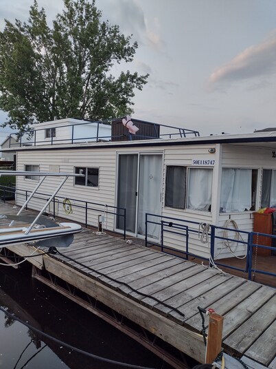 Unique houseboat rental with private dock and land on the historic Rideau River.
