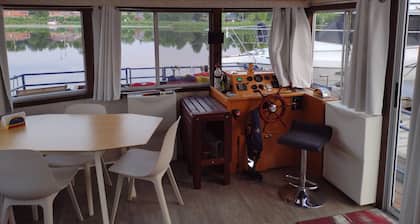 Unique houseboat rental with private dock and land on the historic Rideau River.
