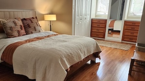A bedroom with a wooden bed, a nightstand, a mirror, a wardrobe, and a window with blinds. - Full of Character and Convenient to Downtown and HPU.    (High Point)