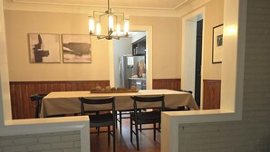 A dining area with a wooden staircase leading to a kitchen. - Full of Character and Convenient to Downtown and HPU.    (High Point)