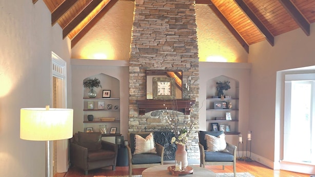 A cozy living room with a stone fireplace, wooden beams, and comfortable seating. - Full of Character and Convenient to Downtown and HPU.    (High Point)