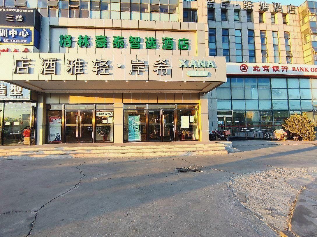 Un hotel con fachada moderna, amplios ventanales y señalización que indica que es un hotel.