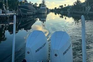 A marina with boats docked and calm water.