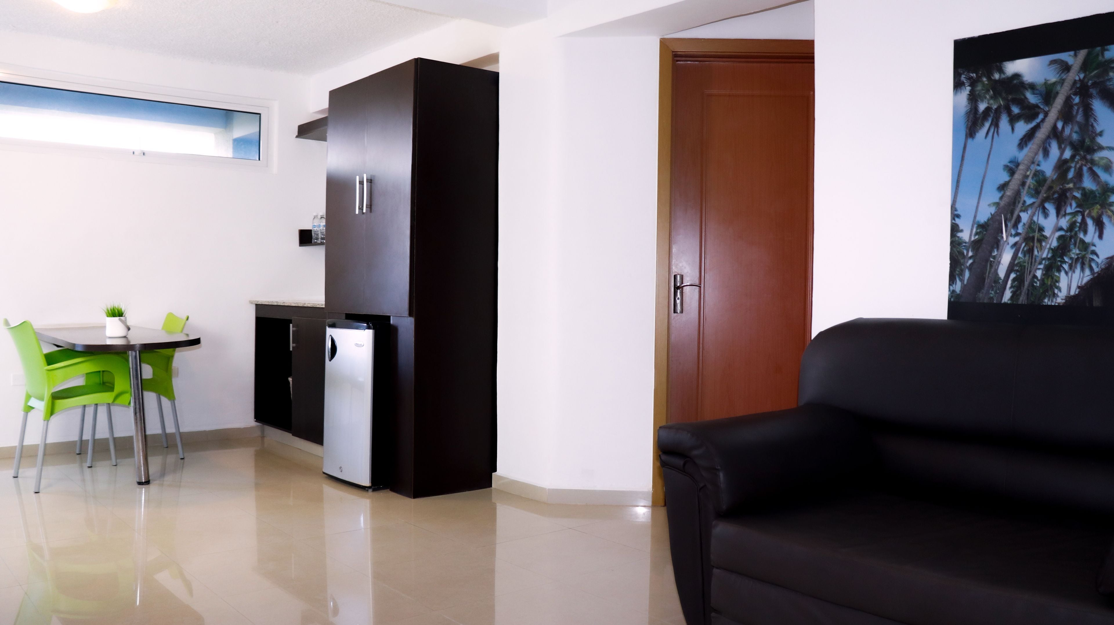 A compact living space with a kitchenette, a dining area, and a seating area.