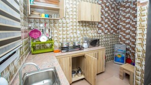 A compact kitchen with a sink, a stove, a microwave, and a small refrigerator. - AJI (1.0)| Luxury 3BED Apartment (Ijegun, Lagos) (Lagos)