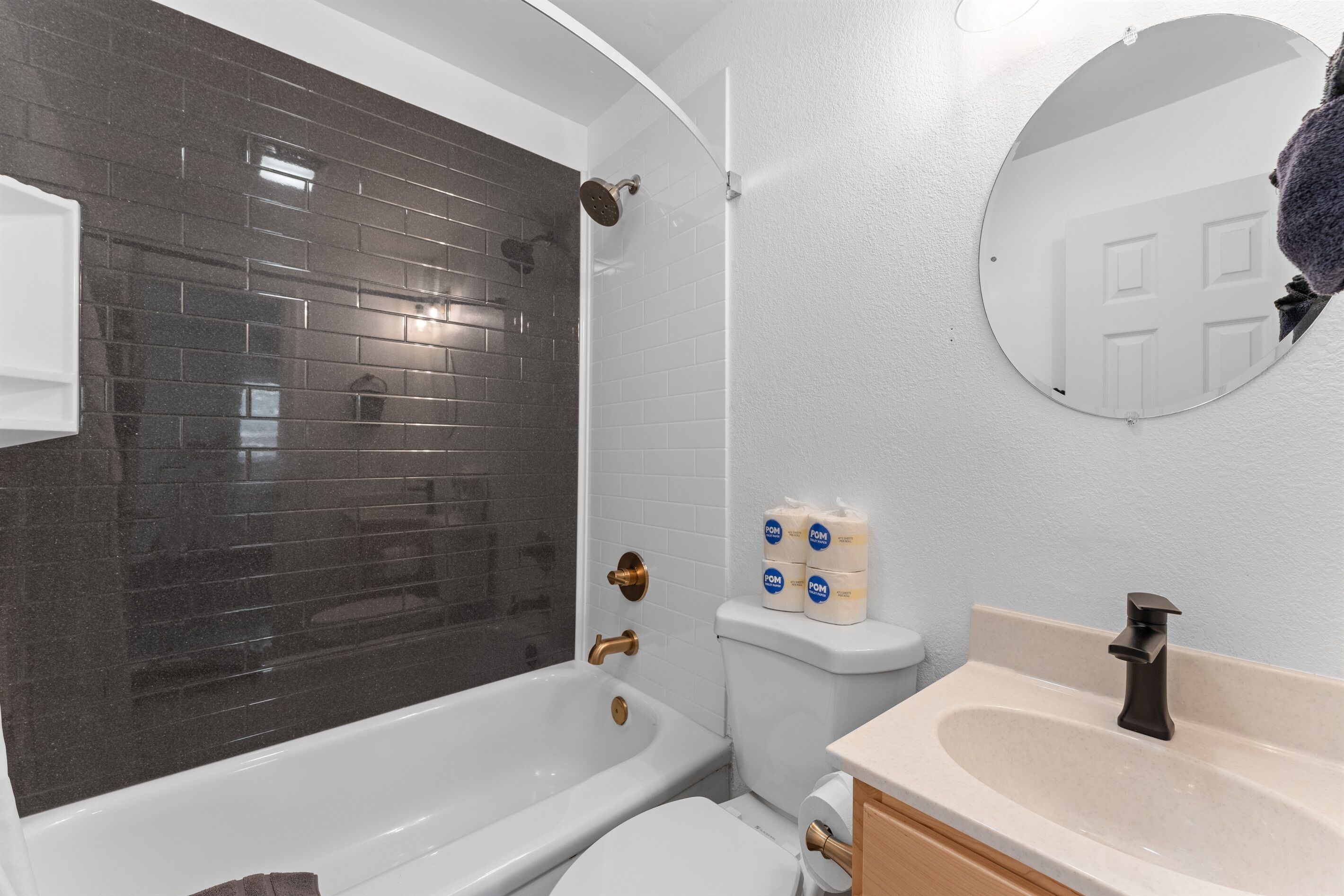 A bathroom with a bathtub, toilet, and sink.