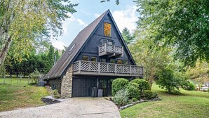 A modern house with a stone facade, a large garage, and a balcony. - Modern A-Frame, Hot Tub, EV, 10 Guests, Dual King, 8 Mins from Downtown Hendersonville (Hendersonville)