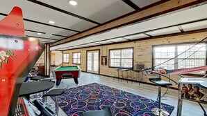A room with a pool table, a dartboard, and a Star Wars poster. - 2BR Waterfront Duplex Cabin w/ Pool + Swim & Boat dock (Branson)