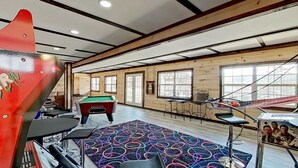 A room with a pool table, a dartboard, and a Star Wars poster. - 1BR Waterfront Cabin w/ Pool + Swim & Boat dock (Branson)