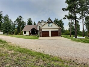 A two-story house with a front porch, a garage, and a driveway.