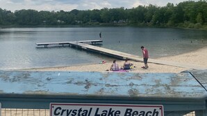 A sign at Crystal Lake Beach stating 'No Glass Containers of any kind.' - Water Rafts + Trails - North Star by Janix Escapes. (Wellston)