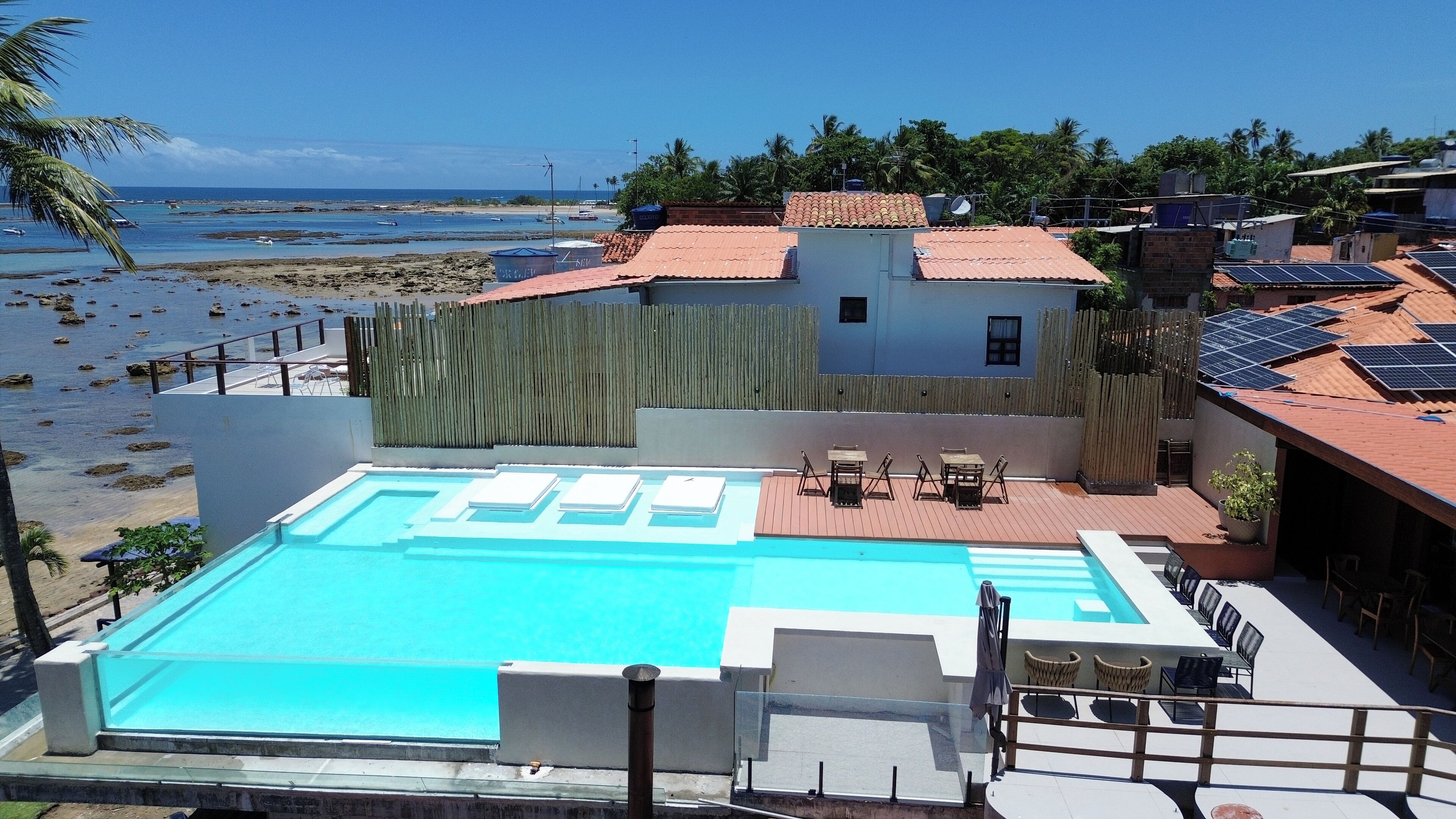 A swimming pool with a view of the beach and ocean.
