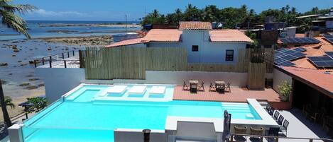 A swimming pool with a view of the beach and ocean.