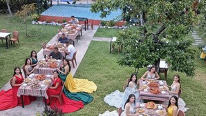 An outdoor dining area with tables set up for a group meal.