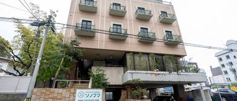 A multi-story building with a sign for a youth hostel.