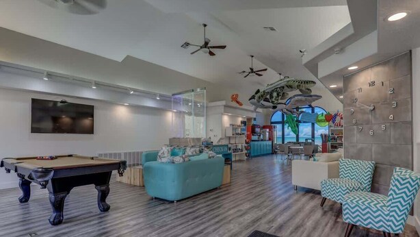 A modern living room with a pool table, sofas, and a dining area. - Las Palmas Resort #1906 | All-Inclusive Amenities (Saint George)