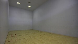 A room with a wooden floor, white walls, and ceiling lights. - Sports Village Resort #H9 | All Amenities Included (Saint George)