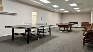 A room with a ping pong table, pool table, and chairs. - Sports Village Resort #H9 | All Amenities Included (Saint George)