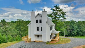 A large, white, two-story house with a prominent chimney, a porch, and a small attached structure. - Timeless Hillsville Farmhouse: Blue Ridge Parkway! (Hillsville)