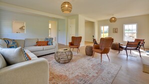 A spacious living room with a sectional sofa, armchairs, a coffee table, and a patterned rug. - Timeless Hillsville Farmhouse: Blue Ridge Parkway! (Hillsville)