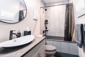 Bathtub, eco-friendly toiletries, hair dryer, towels