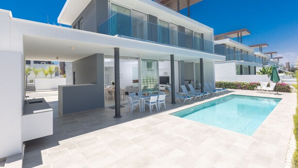 A modern two-story house with a swimming pool, outdoor seating, and a covered patio area. - Protaras Olivine Villa OL9 - Beautiful 4BDR Protaras Villa with Private Pool (Protaras)