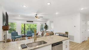 A spacious kitchen with granite countertops, stainless steel appliances, and a ceiling fan. - Lakefront Retreat on Lake Taneycomo, Near Branson Landing and Attractions (Branson)