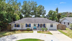 A single-story house with a front porch, a mailbox, and a well-maintained lawn.