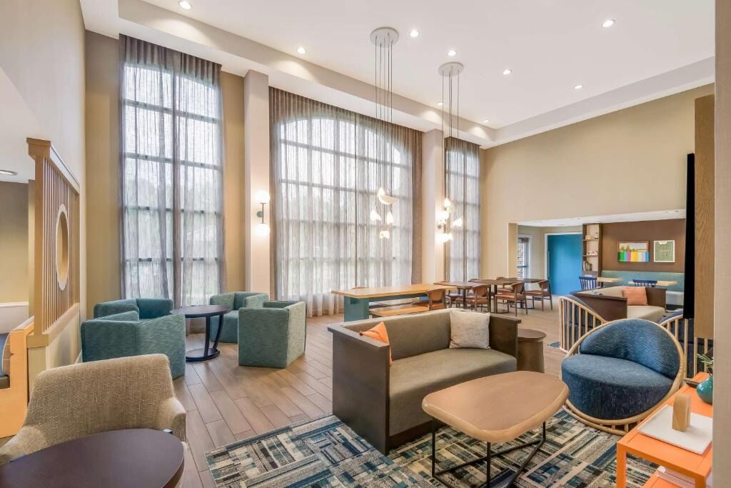 Unwind on plush seating beneath soaring windows and soft light.
