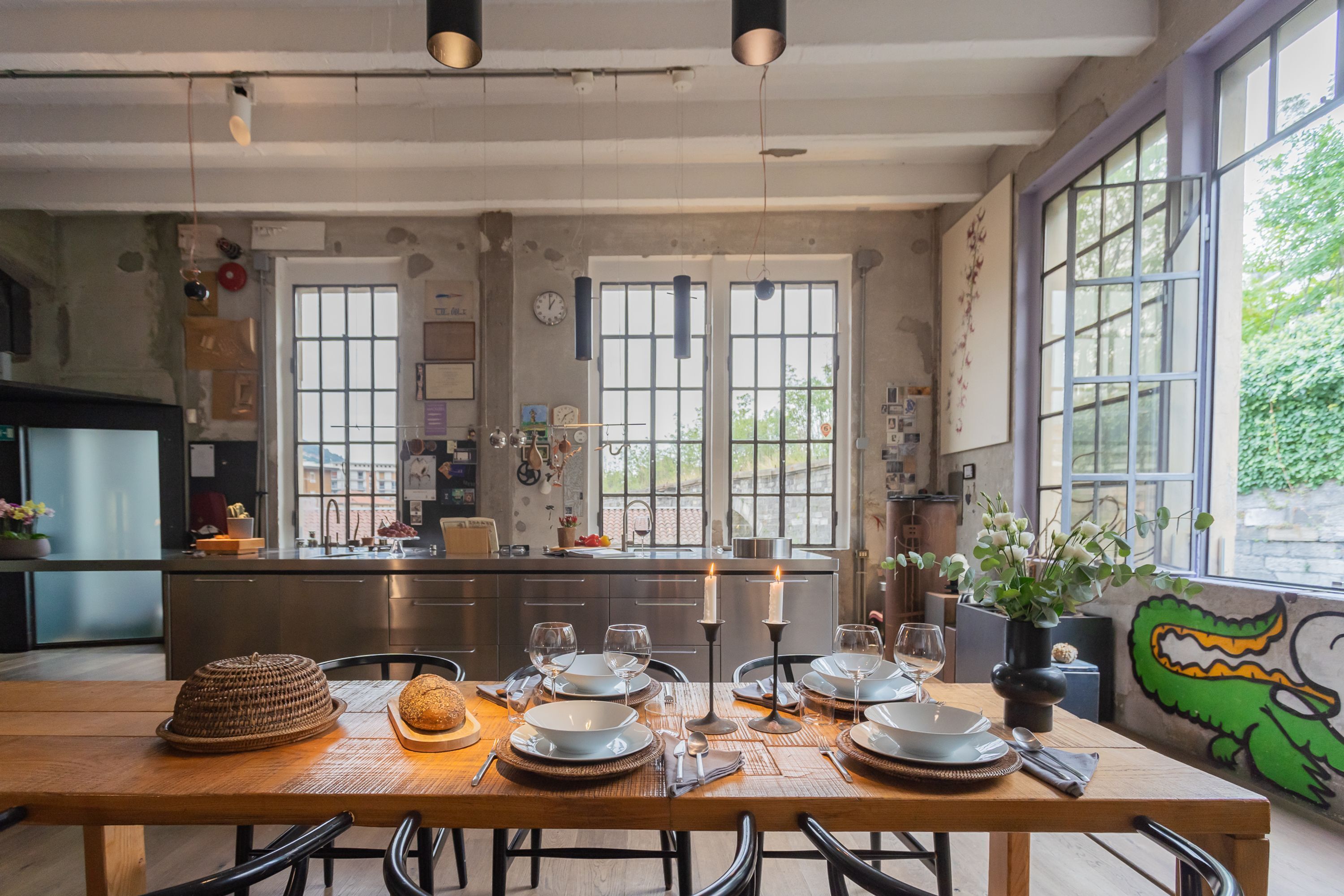 A modern kitchen with a dining area set for a meal.