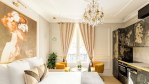 Ein modernes Schlafzimmer mit einem großen Bett, einem Essbereich und einer Küche.